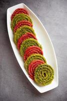 Palak Beetroot chakli or murukku made using spinach and beetroot photo