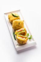 Ulta Vada Pav is made with a spicy potato stuffed bun, called pav inside vada, inside out vada pav photo