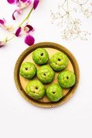 Sitafal peda or pera or custard apple shape designer sweet mithai barfi or burfi photo