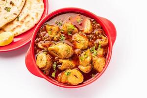 Punjabi soya chaap gravy or dhaba style soya chap masala sabzi served with naan photo