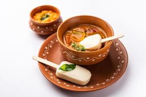 Idly lollipop or idli candy with stick served with sambar and chutney,South indian breakfast photo