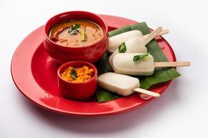 Idly lollipop or idli candy with stick served with sambar and chutney,South indian breakfast photo