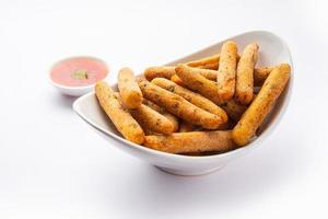 crispy Rava Aloo fingers or Potato semolina fried finger sticks served with ketchup photo