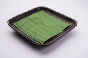 banana leaf on blank plate for edit food or subject on photo