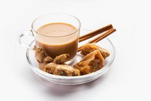 Jaggery tea or Gur ki chai with ingredients like gud, ginger or adrak, green cardamom and cinnamon photo