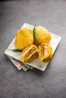 Ulta Vada Pav is made with a spicy potato stuffed bun, called pav inside vada, inside out vada pav photo