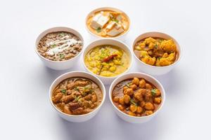 Group of Indian vegetarian dishes, hot and spicy Punjabi cuisine meal assortment in bowls photo