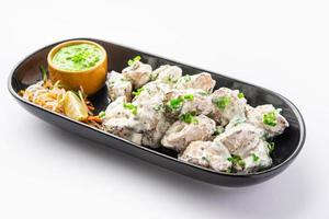 vegetarian soya malai chaap made using soya chaap with white creamy gravy photo