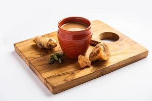 Jaggery tea or Gur ki chai with ingredients like gud, ginger or adrak, green cardamom and cinnamon photo