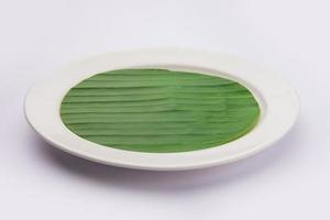 banana leaf on blank plate for edit food or subject on photo