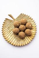 Bajra Atta Ladoo or kuler laddoo - Millet Flour Laddu, a popular winter sweet snack food from India photo