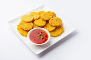 crispy potato rava fried slices or batatyache kaap or batata semolina fry snacks from India photo