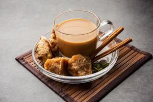 Jaggery tea or Gur ki chai with ingredients like gud, ginger or adrak, green cardamom and cinnamon photo