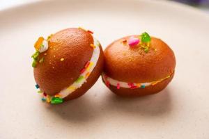 Malai Chop or Cream sandwich made using filling Rasgulla or Gulab jamun sweet is a Bengali sweet photo