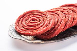 Beatroot chakli, murukku, Beetroot chakli, a spiral fried snack from India made in Diwali festival photo