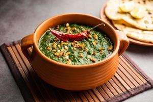 lasooni palak recipe or dhaba style garlic spinach curry, Indian main course served with naan photo