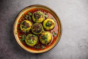 Indian style Tinda or Tinde ki Sabzi also called Indian squash, round melon, Indian round gourd or Indian baby pumpkin, stuffed, stir fried dry or curry recipe