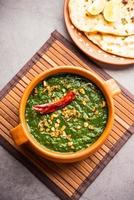 lasooni palak recipe or dhaba style garlic spinach curry, Indian main course served with naan photo