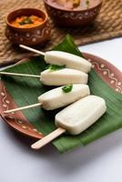 Idly lollipop or idli candy with stick served with sambar and chutney,South indian breakfast photo