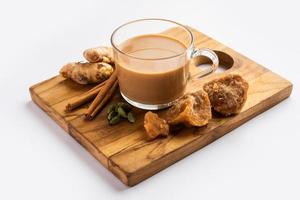 Jaggery tea or Gur ki chai with ingredients like gud, ginger or adrak, green cardamom and cinnamon photo