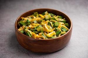 Bhindi do pyaza is a restaurant style North Indian dish made with okra or ladies finger with spices, herbs and lots of onions photo