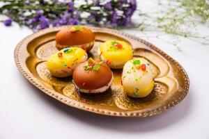 Malai Chop or Cream sandwich made using filling Rasgulla or Gulab jamun sweet is a Bengali sweet photo