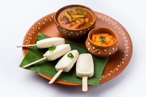 Idly lollipop or idli candy with stick served with sambar and chutney,South indian breakfast photo