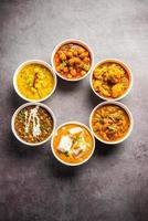 Group of Indian vegetarian dishes, hot and spicy Punjabi cuisine meal assortment in bowls photo