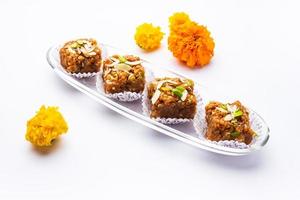 Dodha Barfi or Doda Burfi is a traditional Indian sweet, which has a grainy and chewy texture photo