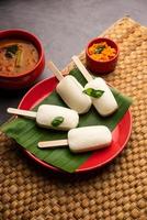 Idly lollipop or idli candy with stick served with sambar and chutney,South indian breakfast photo