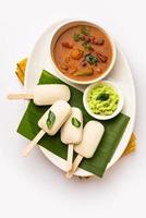 Idly lollipop or idli candy with stick served with sambar and chutney,South indian breakfast photo