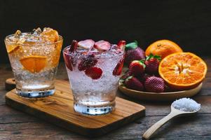 sweet fruits beverage strawberry soda and orange soda cold drink vitamin fruit, tasty drinks on wood table photo