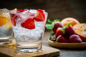 sweet fruits beverage strawberry soda and orange soda cold drink vitamin fruit, tasty drinks on wood table photo