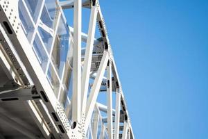 Steel frame bridge on blue sky background. photo