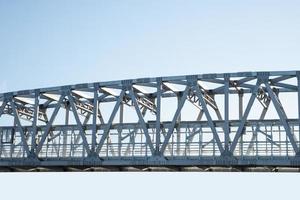 Iron frame bridge on clear sky background. photo