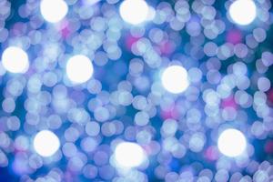 Abstract bokeh lights. Bokeh blur of lights at night. Bright blue, gold, white glow circle background for festive, Christmas, and new year. with copy photo