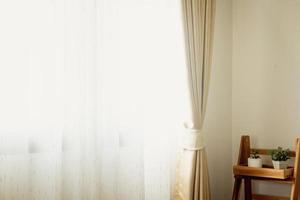 hermosa escena de cortina blanca ventanas y muros cortina la luz y la sombra del clima de la tarde colores cálidos que brillan a través de cortinas de seda o cortinas en el interior. foto