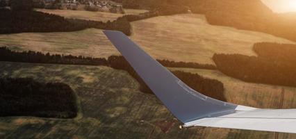 aerial view of landscape with view of aircraft wing photo