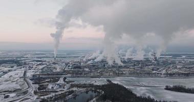 aerial winter view on smoked pipes of chemical enterprise plant. Air pollution concept. Industrial winter landscape environmental pollution waste of thermal power plant video