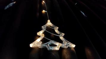 A Christmas decoration that has shaped like a Christmas tree made of glass with led lights video
