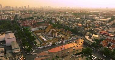 An aerial view of Red Giant Swing and Suthat Thepwararam Temple at sunset scene, The most famous tourist attraction in Bangkok, Thailand