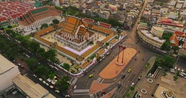 An aerial view of Red Giant Swing and Suthat Thepwararam Temple at sunset scene, The most famous tourist attraction in Bangkok, Thailand