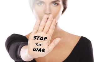 Woman activist showing her palm with STOP THE WAR phrase photo