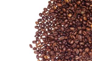 Pile of roasted coffee beans on white background photo