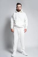 Handsome man wearing blank white hoodie and pants photo