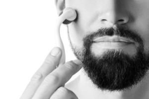 Man using meso roller for better beard growth photo