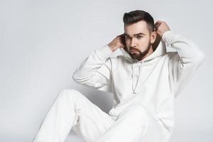 Handsome man wearing blank white hoodie and pants photo