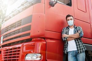 Truck driver wearing protective mask because of virus pandemic photo