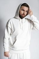 Handsome man wearing blank white hoodie and pants photo