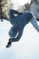 Young athletic woman warming up before her winter workout photo